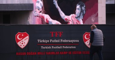 A man walks outside the Turkish Football Federation headquarters, in Istanbul, Turkey, Wednesday, Nov. 12, 2025. (AP Photo/Francisco Seco)