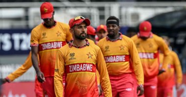 Zimbabwe's captain Sikandar Raza and his teammates arrive for their national anthem before the start of the 2026 ICC Men's T20 Cricket World Cup group stage match between Sri Lanka and Zimbabwe at the R Premadasa Stadium, Colombo, Sri Lanka, Feb. 19, 2026. (AFP Photo)