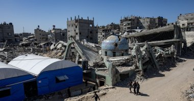 Palestinians walk beside the ruins of the al-Huda Mosque destroyed by Israel after the first Friday prayer of the holy month of Ramadan in the city of Khan Younis, Gaza Strip, Feb. 20, 2026. (EPA Photo)