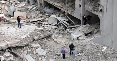 People inspect a destroyed building following an Israeli air strike in the village of Qannarit, southern Lebanon, Jan. 22, 2026. (EPA Photo)
