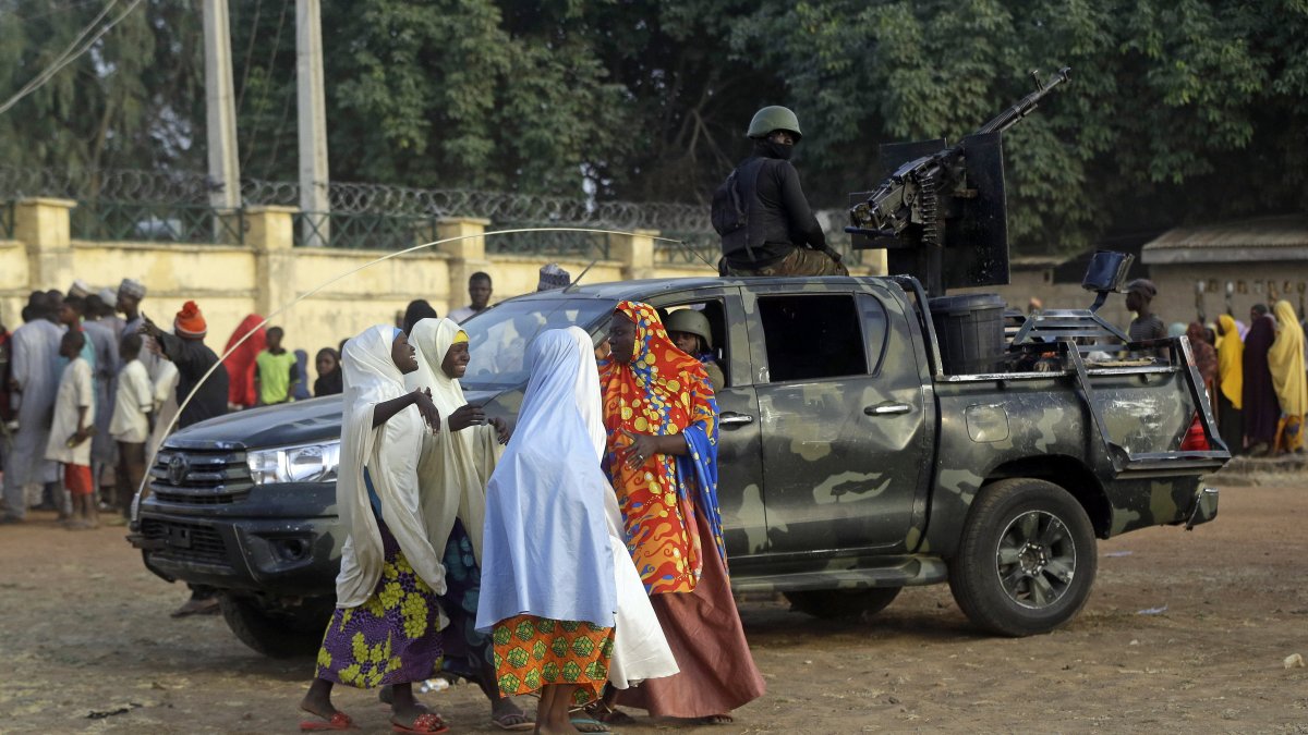 Parents are reunited with their abducted daughters in Jangabe, Zamfara state, Nigeria, March 3, 2021. (AP Photo)