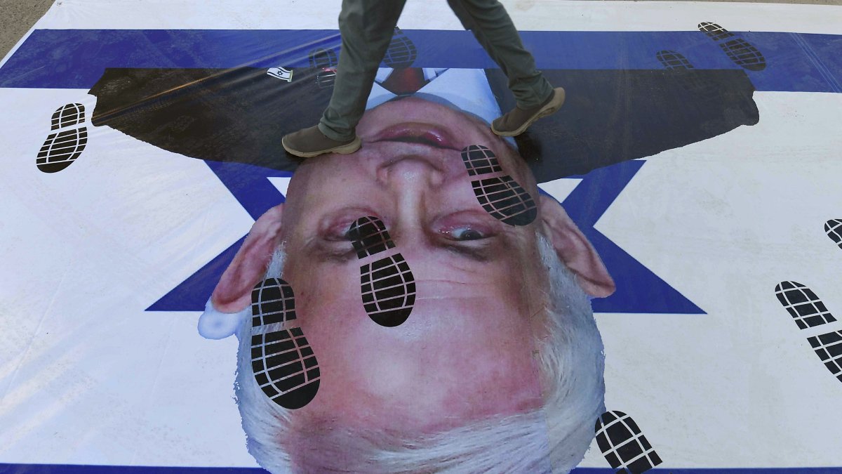 A protester steps on an Israeli flag featuring the image of Israeli Prime Minister Benjamin Netanyahu during a rally, Karachi, Pakistan, Feb. 15, 2026. (EPA Photo)
