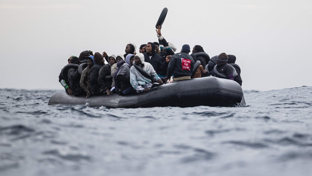 Migrants onboard a rubber boat wave and gesture as they wait to be rescued by crew members of the "Ocean Viking” rescue ship in the search-and-rescue zone in the Mediterranean Sea near the Libyan coast, Jan. 16, 2026. (AFP Photo)