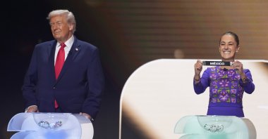 Mexican President Claudia Sheinbaum (R) holds up the team name of Mexico as President Donald Trump looks on during the draw for the 2026 World Cup at the Kennedy Center, Washington, U.S., Dec. 5, 2025. (AP Photo)