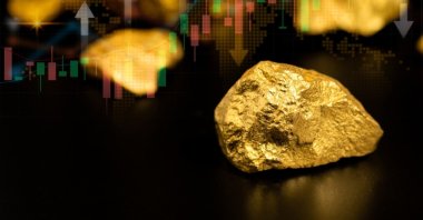 Gold ore with a background of a gold price graph in this undated illustration. (Shutterstock Photo)