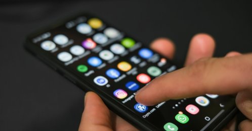 A phone home screen displaying social media applications. (Shutterstock Photo) 