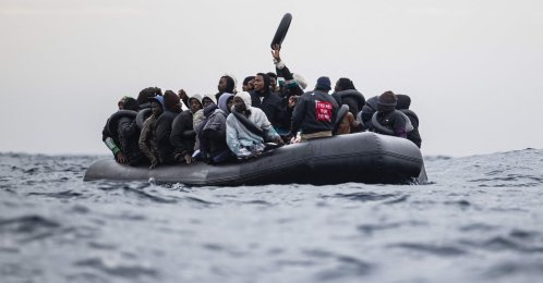 Migrants onboard a rubber boat wave and gesture as they wait to be rescued by crew members of the "Ocean Viking” rescue ship in the search-and-rescue zone in the Mediterranean Sea near the Libyan coast, Jan. 16, 2026. (AFP Photo)
