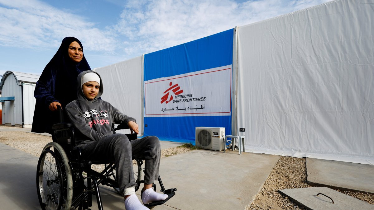A Palestinian woman helps a burn victim, Maria Abu Aawad, at a Doctors Without Borders (MSF) hospital, amid severe shortages of medical equipment, medicines and essential materials needed for burn treatment, in Zawaida, in the central Gaza Strip, Jan. 26, 2026. (Reuters Photo)