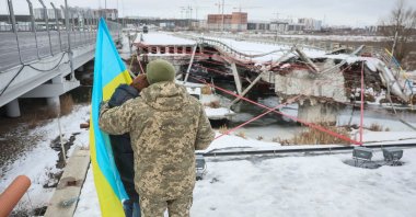 People attend a memorial event to mark the fourth anniversary of the full-scale Russian invasion, amid Russia's attack on Ukraine, at Romanivskyi Bridge, which was destroyed at the beginning of the war and which was the main way for evacuations of civilians from the front line area around the Ukrainian capital, in Irpin, outside of Kyiv, Ukraine, Feb. 24, 2026. (Reuters Photo)