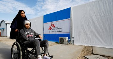 A Palestinian woman helps a burn victim, Maria Abu Aawad, at a Doctors Without Borders (MSF) hospital, amid severe shortages of medical equipment, medicines and essential materials needed for burn treatment, in Zawaida, in the central Gaza Strip, Jan. 26, 2026. (Reuters Photo)