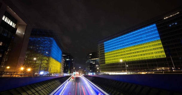 This photograph shows a general view of the European Union Council building (L) and the European Union Commission building illuminated and bearing the colors of Ukraine's national flag, Brussels, Belgium, Feb. 23, 2026. (AFP Photo)
