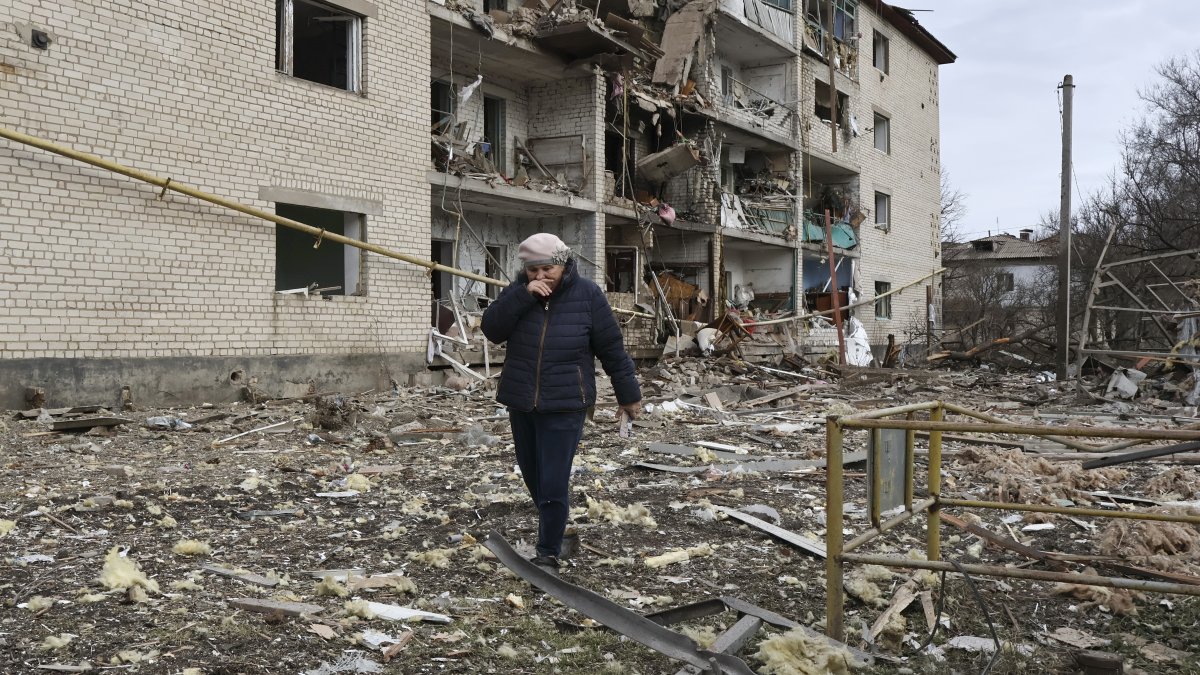 This file photo shows a Ukrainian woman among the rubble of a residential area in the Zaporizhzhia region, Ukraine, Feb. 20, 2026. (EPA Photo)