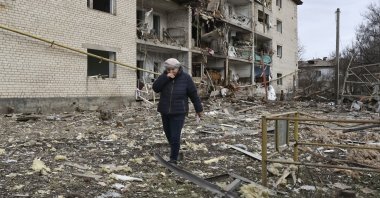This file photo shows a Ukrainian woman among the rubble of a residential area in the Zaporizhzhia region, Ukraine, Feb. 20, 2026. (EPA Photo)