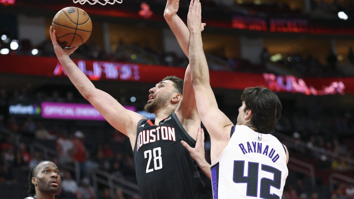 Houston Rockets center Alperen Şengün (L) scores a basket as Sacramento Kings center Maxime Raynaud defends during the first quarter at Toyota Center, Houston, U.S., Feb. 25, 2026. (Reuters Photo)