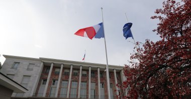 French national flags and an European Union flag are lowered at half staff over the French Embassy as embassy personnel and members of the French community observe a minute of silence, Ankara, Türkiye, Nov. 16, 2015. (AP Photo)