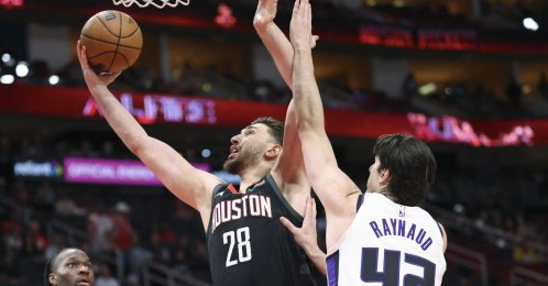 Houston Rockets center Alperen Şengün (L) scores a basket as Sacramento Kings center Maxime Raynaud defends during the first quarter at Toyota Center, Houston, U.S., Feb. 25, 2026. (Reuters Photo)