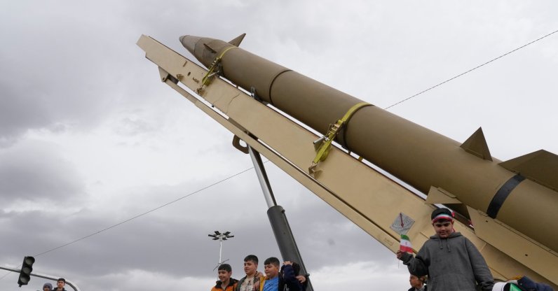Boys stand on a launcher of an Iranian domestically-built missile during an annual rally marking the 1979 Islamic Revolution at the Azadi (Freedom) square, Tehran, Iran, Feb. 11, 2026. (AP Photo)