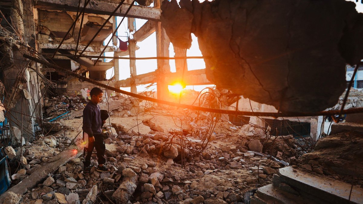 A displaced Palestinian boy walks over the rubble in the Bureij refugee camp, central Gaza Strip, Palestine, Feb. 25, 2026. (AFP Photo)