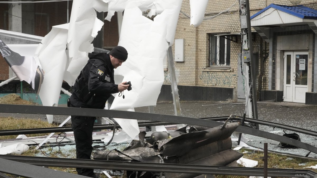 A man stands next to damage following Russian shelling, Kyiv, Ukraine, Feb. 24, 2022. (AP Photo)