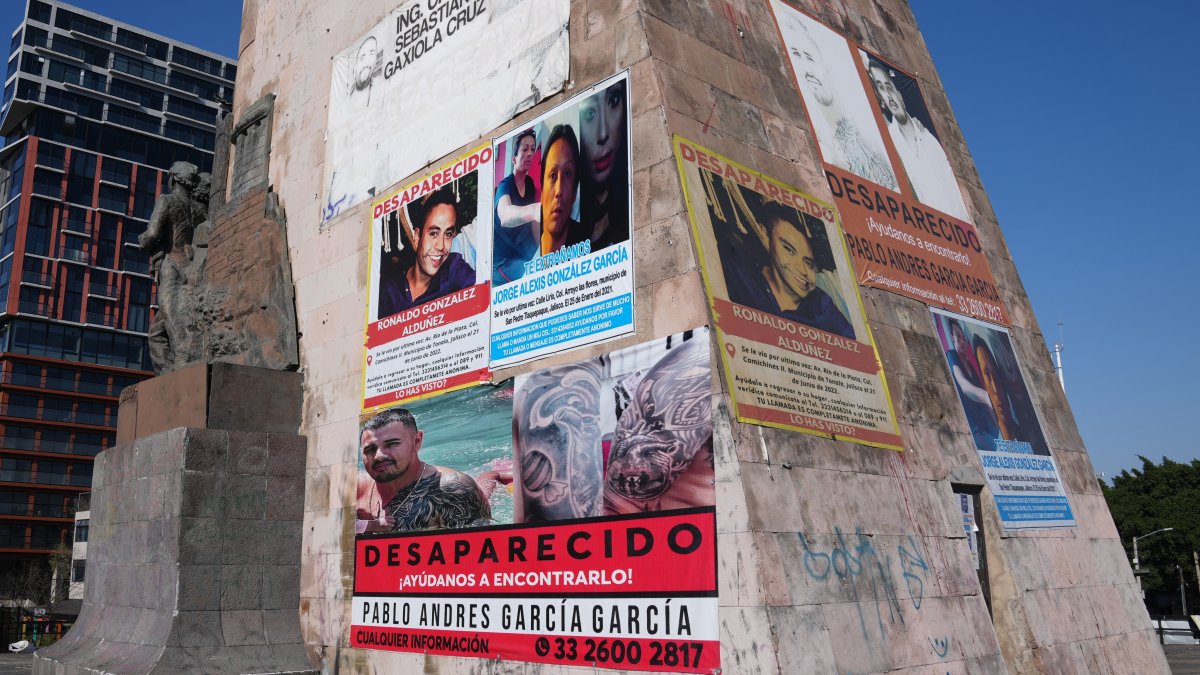Posters bearing the faces of missing people cover the Ninos Heroes monument, Guadalajara, Mexico, Feb. 25, 2026. (AP Photo)