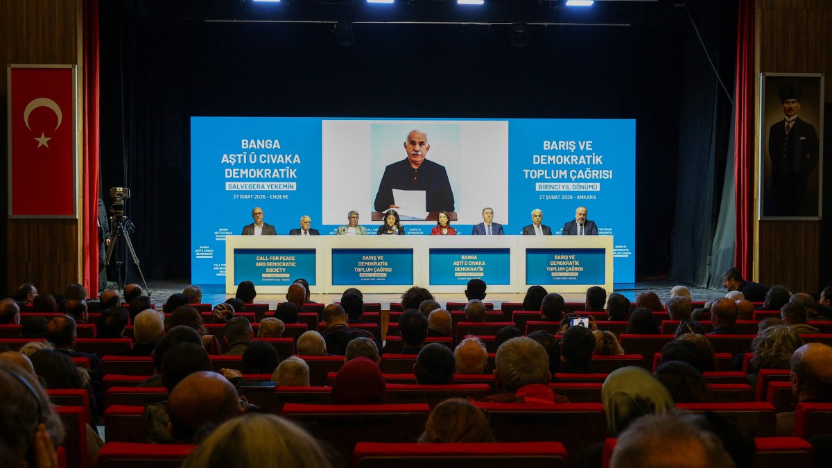 Ahmet Türk, Pervin Buldan, Tulay Hatimoğulları, Tuncer Bakırhan, Cengiz Çiçek, Veysi Aktaş, Mithat Sancar and Faik Özgür Erol, politicians and lawmakers from the pro-PKK Peoples' Equality and Democracy Party (DEM Party), sit in front of a picture taken in Imrali Island prison of the jailed PKK leader Abdullah Öcalan, during a press conference, Ankara, Türkiye, Feb. 27, 2026. (Reuters Photo)