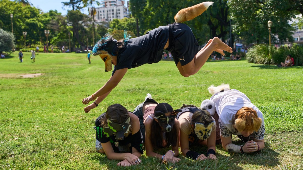 A youth jumps over other "therians," people who say they identify as non-human animals, during a gathering in a square in Buenos Aires, Argentina, Feb. 22, 2026. (AP Photo)