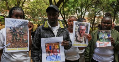 Family members of Kenyans who joined the Russian army in Ukraine hold photos of their loved ones during a protest calling on the government to urgently repatriate them and their remains, Nairobi, Kenya, Feb. 19, 2026. (AP Photo)