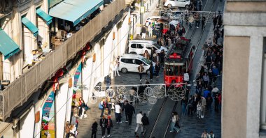 The historic red tram moves along Istiklal Avenue amid crowds in Beyoğlu, Istanbul, Türkiye, Oct. 28, 2025. (Shutterstock Photo)