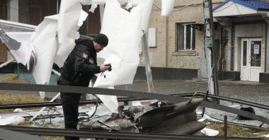A man stands next to damage following Russian shelling, Kyiv, Ukraine, Feb. 24, 2022. (AP Photo)