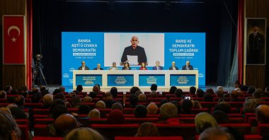Ahmet Türk, Pervin Buldan, Tulay Hatimoğulları, Tuncer Bakırhan, Cengiz Çiçek, Veysi Aktaş, Mithat Sancar and Faik Özgür Erol, politicians and lawmakers from the pro-PKK Peoples' Equality and Democracy Party (DEM Party), sit in front of a picture taken in Imrali Island prison of the jailed PKK leader Abdullah Öcalan, during a press conference, Ankara, Türkiye, Feb. 27, 2026. (Reuters Photo)