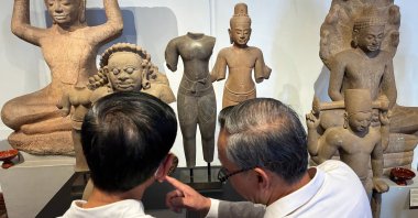 Cambodian officials look at Khmer cultural artifacts that were returned to the country, at the National Museum, Phnom Penh, Cambodia, Feb. 27, 2026. (AP Photo)