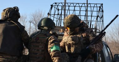 Ukrainian servicemen ride a military pickup to the frontline position at an undisclosed location in the Zaporizhzhia region, Feb. 10, 2026. (Handout via AFP)