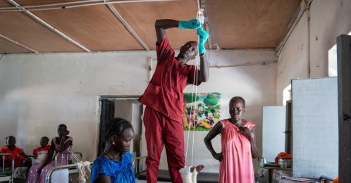 Nyayual Chuol (R) watches her 18-month-old grandson Kool Gatyen Pajock, who was shot during the conflict-hit state, receive treatment at the Akobo County Hospital, South Sudan, Feb. 21, 2026. (AP Photo)