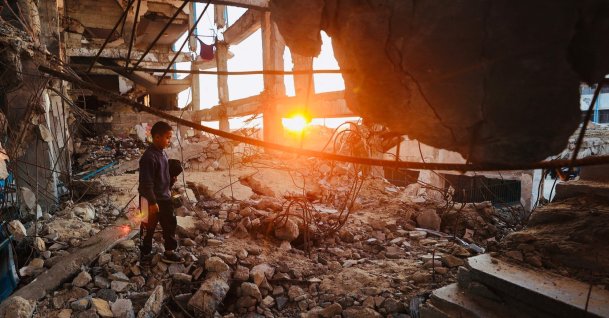 A displaced Palestinian boy walks over the rubble in the Bureij refugee camp, central Gaza Strip, Palestine, Feb. 25, 2026. (AFP Photo)