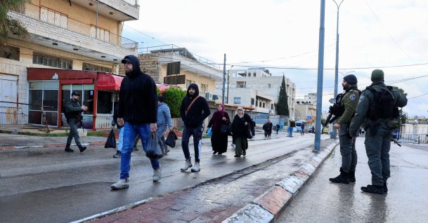 Palestinians walk to an Israeli checkpoint, as they make their way to the al-Aqsa compound, in Jerusalem's Old City, to attend Friday prayers in Bethlehem in the Israeli-occupied West Bank, Feb. 27, 2026. (Reuters Photo)