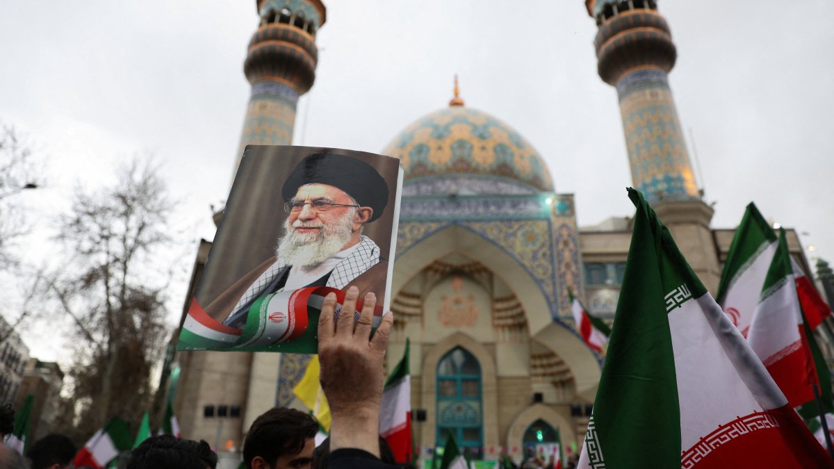 A person holds an image of Iran's Supreme Leader Ayatollah Ali Khamenei as Iranian demonstrators protest against the U.S.-Israeli strikes, in Tehran, Iran, Feb. 28, 2026. (Reuters Photo)