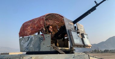 A Taliban security personnel sits atop an armored Humvee while keeping watch near the Torkham border crossing between Afghanistan and Pakistan in the Nangarhar province, Feb. 28, 2026. (AFP Photo)