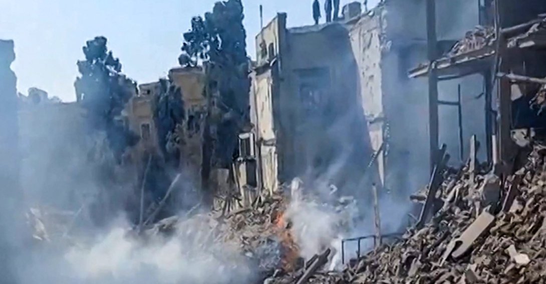 This video grab taken from UGC images posted on social media on Feb. 28, 2026 and verified by AFPTV teams in Paris shows people inspecting the damage at an impact site following U.S. and Israeli strikes on Tehran. (AFP Photo)
