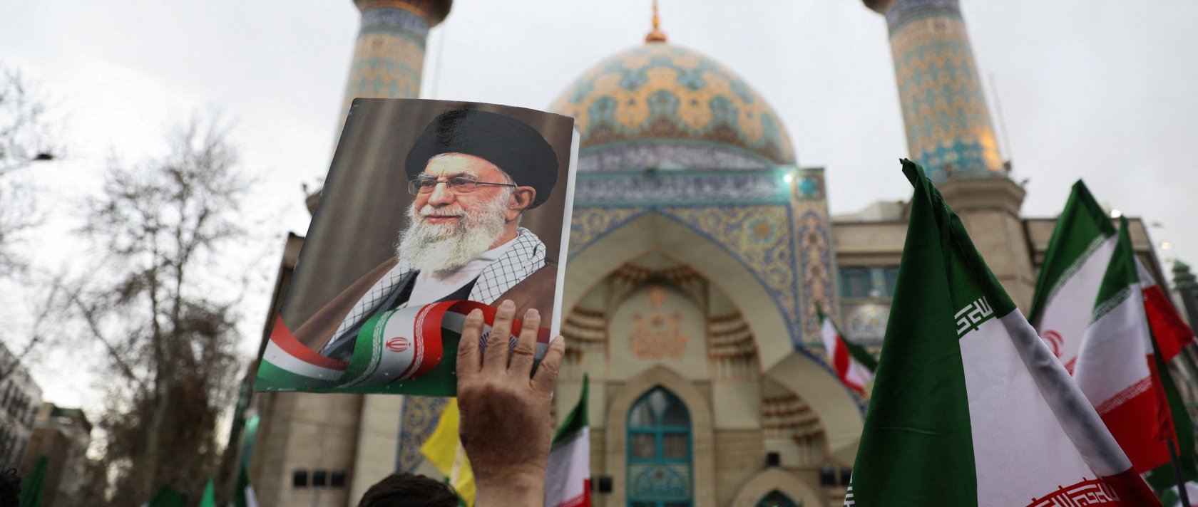 A person holds an image of Iran's Supreme Leader Ayatollah Ali Khamenei as Iranian demonstrators protest against the U.S.-Israeli strikes, in Tehran, Iran, Feb. 28, 2026. (Reuters Photo)