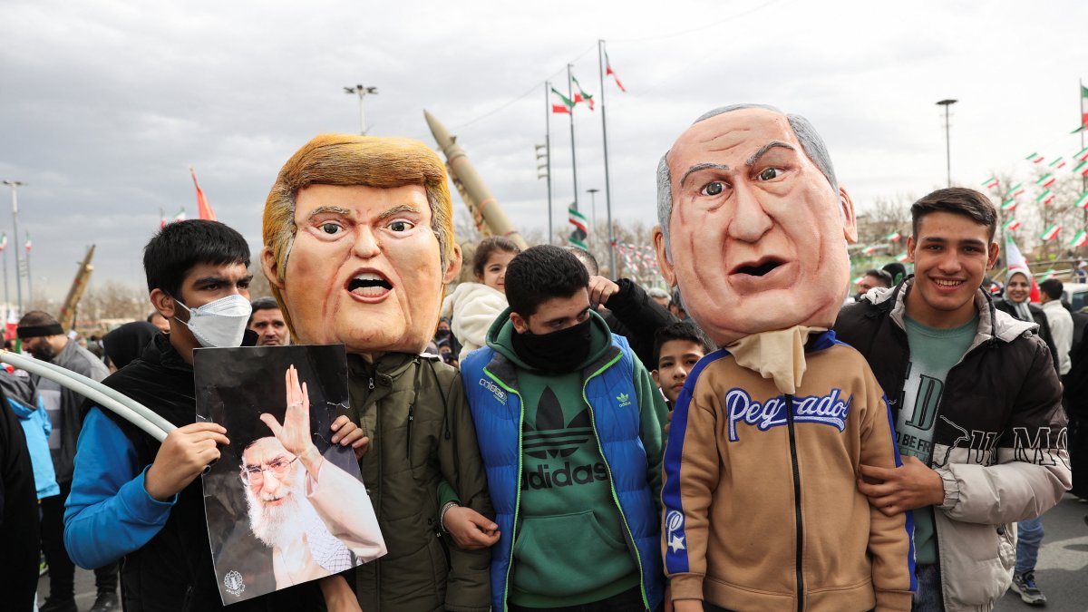 Attendees wear masks depicting U.S. President Donald Trump and Israeli Prime Minister Benjamin Netanyahu, during the 47th anniversary of the Islamic Revolution, Tehran, Iran, Feb. 11, 2026. (Reuters Photo)