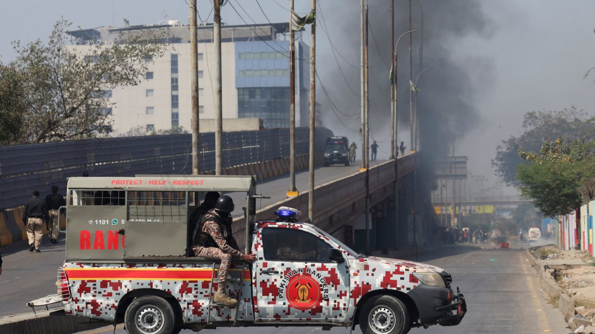 Paramilitary force vehicle is parked on a road as smoke rises in the background, after a protest outside the U.S. Consulate General, following news of U.S. and Israeli strikes on Iran that killed Iran's Supreme Leader Ayatollah Ali Khamenei, in Karachi, Pakistan, March 1, 2026. (Reuters Photo)