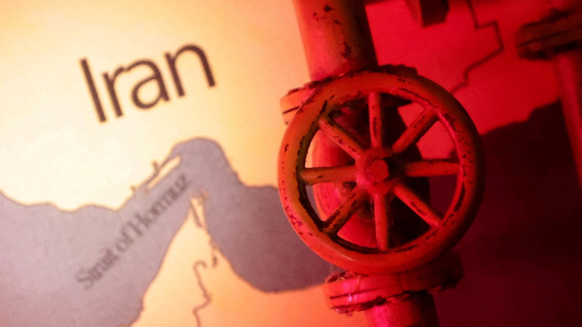 A map showing the Strait of Hormuz and Iran is seen behind a 3D printed oil pipeline in this illustration, June 22, 2025. (Reuters Photo)