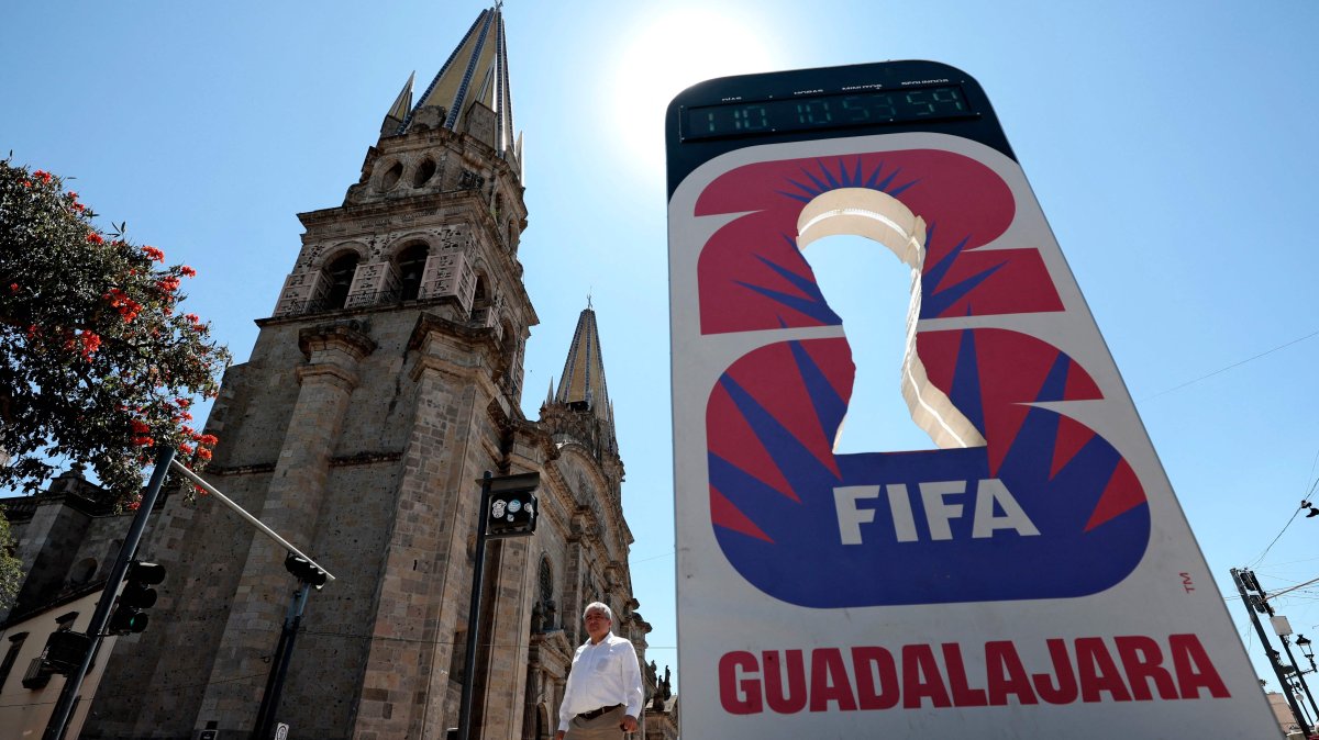 A man walks past a clock counting down the days for the 2026 FIFA World Cup next to the Cathedran in Guadalajara, Jalisco state, Mexico, Feb. 20, 2026. (AFP Photo)