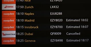 The arrivals board is seen, showing a cancelled flight from Dubai, in the north terminal at London Gatwick Airport, Crawley, U.K., Feb. 28, 2026. (AFP Photo)