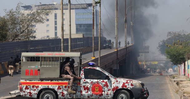 Paramilitary force vehicle is parked on a road as smoke rises in the background, after a protest outside the U.S. Consulate General, following news of U.S. and Israeli strikes on Iran that killed Iran's Supreme Leader Ayatollah Ali Khamenei, in Karachi, Pakistan, March 1, 2026. (Reuters Photo)