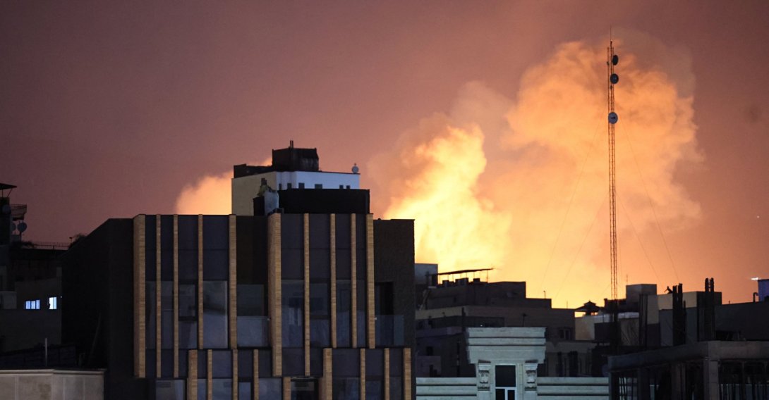Smoke and flames rise behind buildings after an explosion on the second consecutive day of strikes by the U.S. and Israel, in Tehran, Iran, March 1, 2026. (EPA Photo)