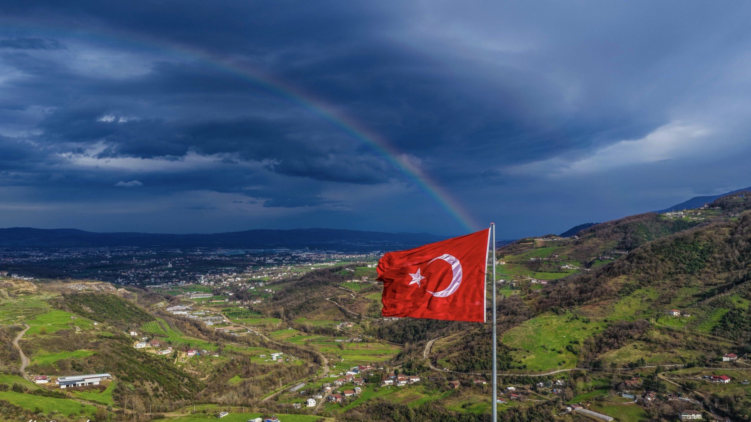 After the rainy weather, the Turkish flag waves as a rainbow appears in the sky, Kocaeli, Türkiye, March, 1, 2026. (İHA Photo)