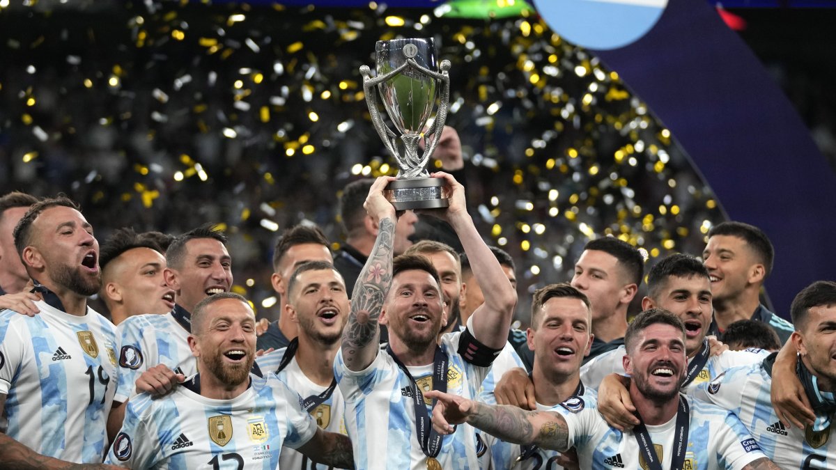 Argentina's Lionel Messi holds a trophy as he celebrates with his teammates after winning the Finalissima soccer match between Italy and Argentina at Wembley Stadium, London, U.K., June 1, 2022. (AP Photo)