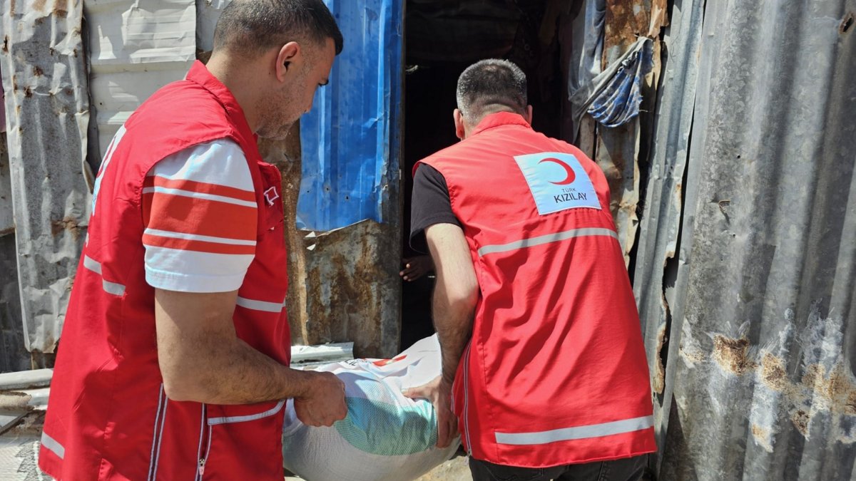 Two Turkish Red Crescent (Kızılay) volunteers distribute food packages to families in need during Ramadan, March 2, 2026. (AA Photo) 