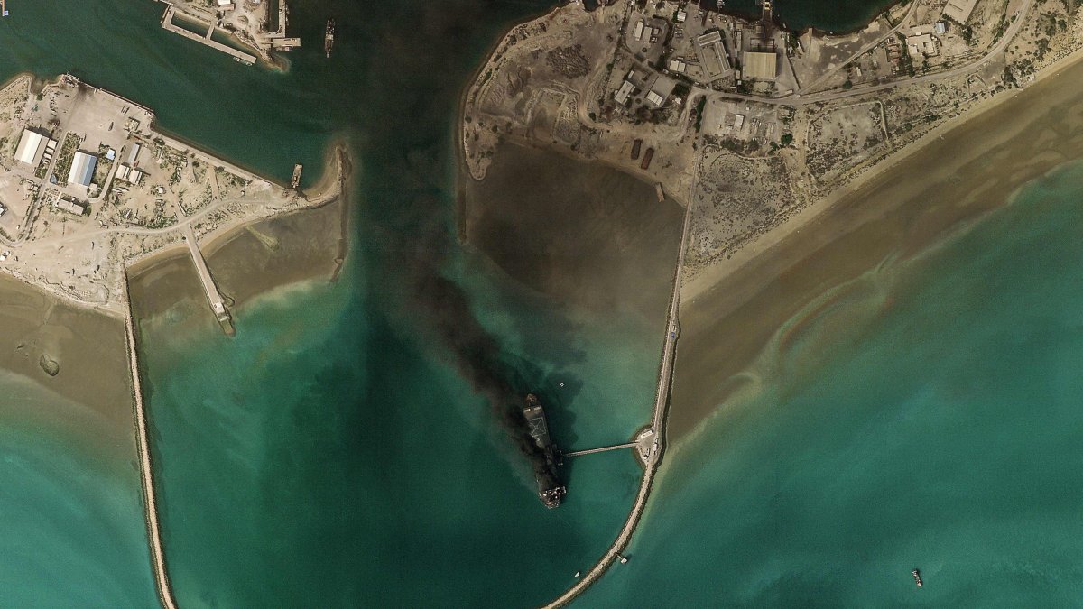This handout satellite image taken by 2026 Planet Labs PBC shows smoke billowing from a vessel following an explosion from the port of Bandar Abbas along the strait of Hormuz, March 2, 2026. (AFP Photo)